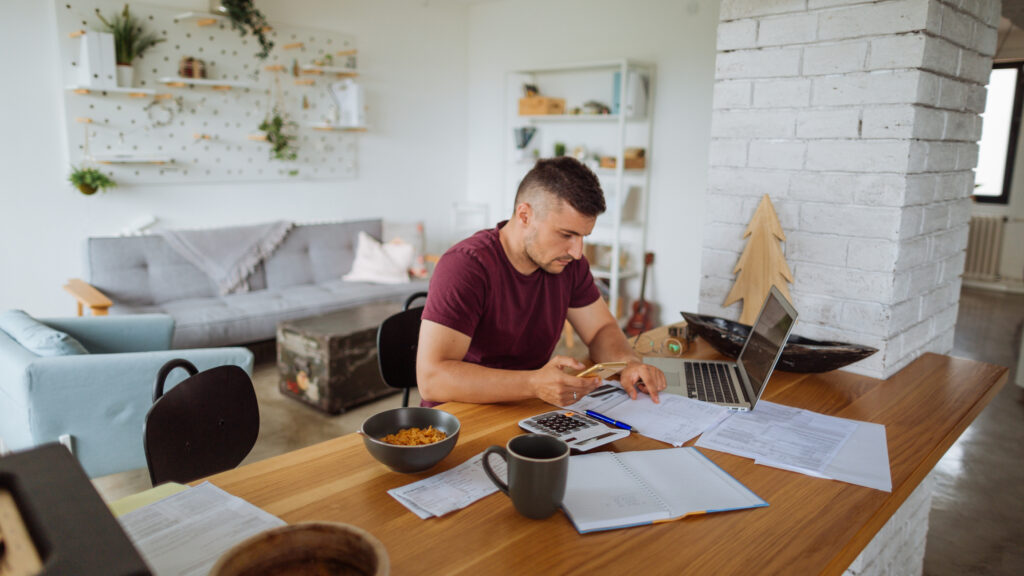 Young Man at home with his finances