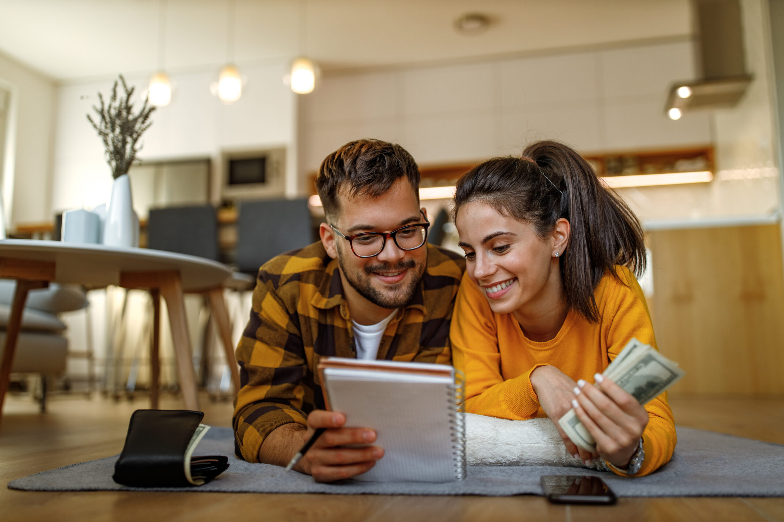 Young couple counting money together and making their budget.